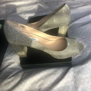 Silver peep toe pumps with block heel.